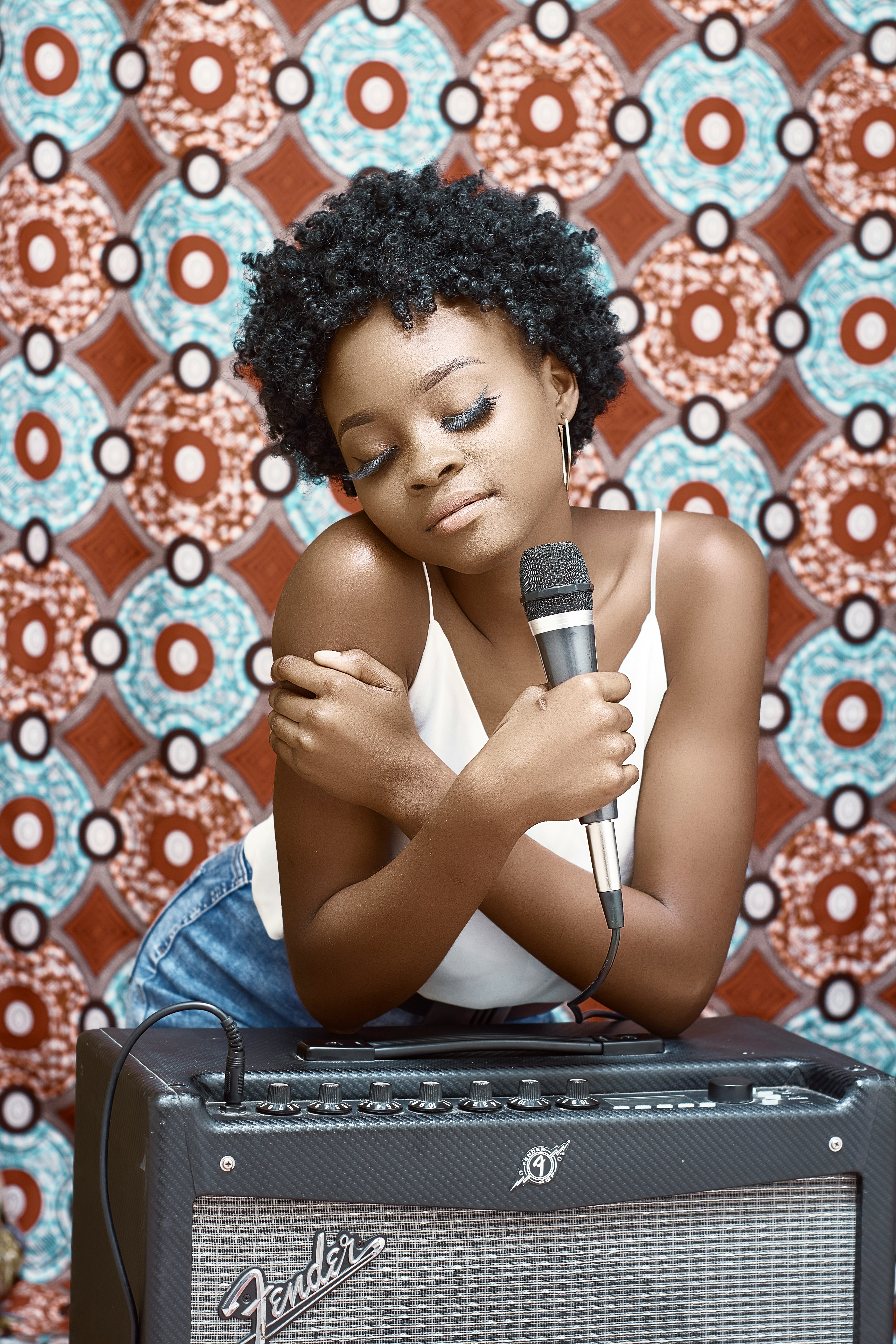 woman in blue denim jacket holding microphone